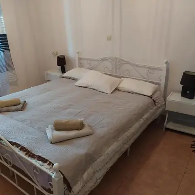 a bed with two towels on it in a bedroom at Nymph in Sálakos