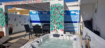 a jacuzzi tub in the middle of a patio at Stergios top view residence with jacuzzi in Kolimbia