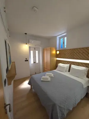 a bedroom with a large bed with two towels on it at Dorian Hotel in Symi
