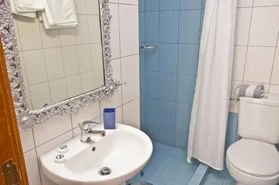 a bathroom with a sink and a toilet at Dorian Hotel in Symi