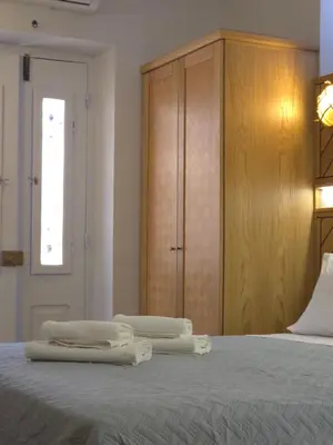 a bedroom with two towels sitting on top of a bed at Dorian Hotel in Symi