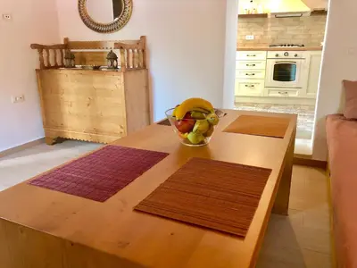 a kitchen with a table with a bowl of fruit on it at Bekos traditional house in Archangelos