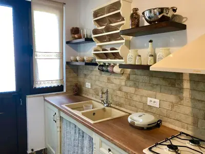 a kitchen with a sink and a counter top at Bekos traditional house in Archangelos
