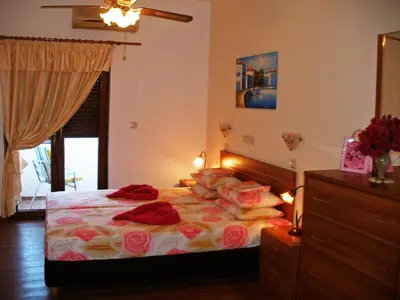 a bedroom with a bed with flowers on it at Apollo Studios in Livadia