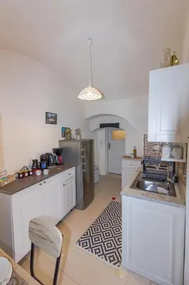 a kitchen with white cabinets and a sink at Galini Apartments Old Town in Rhodes Town
