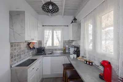 a kitchen with white cabinets and a counter top at Galini Apartments Old Town in Rhodes Town