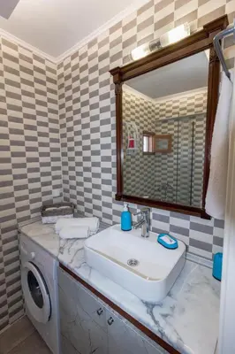 a bathroom with a sink and a mirror at Galini Apartments Old Town in Rhodes Town