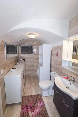 a bathroom with a white toilet and a sink at Galini Apartments Old Town in Rhodes Town