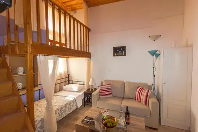 a living room with a couch and a bunk bed at Galini Apartments Old Town in Rhodes Town