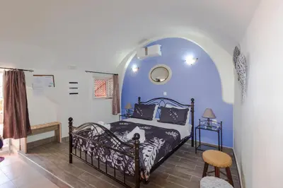 a bedroom with a bed in a blue room at Galini Apartments Old Town in Rhodes Town