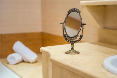 a mirror sitting on top of a counter in a bathroom at MeFoMi Villa in Rhodes Town