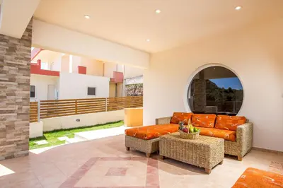 a living room with a couch and a chair at MeFoMi Villa in Rhodes Town