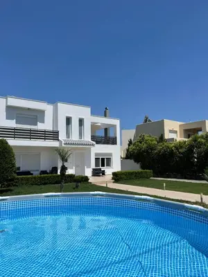 a large swimming pool in front of a house at Villa Epavlis Haraki in Haraki