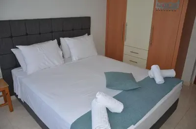 a bedroom with a bed with towels on it at Platoni Elite Villas in Ialyssos