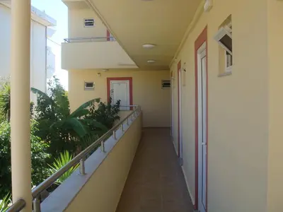 an empty hallway of a building with plants at Billy's Studios in Faliraki