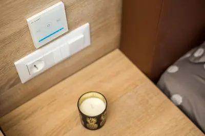 a room with a lightswitch and a candle on a table at Billy's Studios in Faliraki