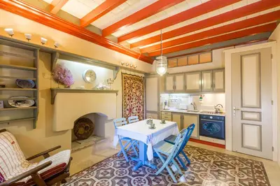 a kitchen with a table and chairs in a room at Villa Ricolas in Symi