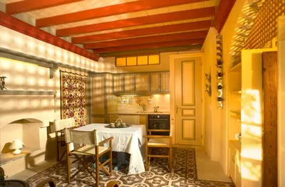 a kitchen with a table and chairs in a room at Villa Ricolas in Symi