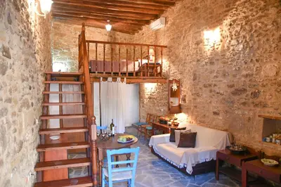 a living room with a loft bed and a staircase at Stone house in Rhodes Town
