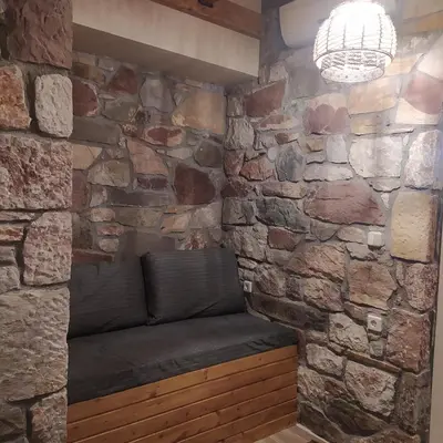 a stone wall with a bench in a room at Ataviros Hotel in Émbonas