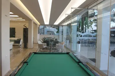 a pool table in the middle of a living room at Vallian Village Hotel in Paradeísion
