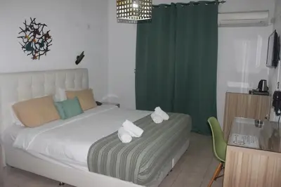a bedroom with a bed with towels on it at Vallian Village Hotel in Paradeísion