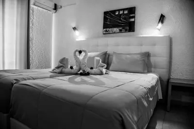 two stuffed animals sitting on top of a bed at Vallian Village Hotel in Paradeísion