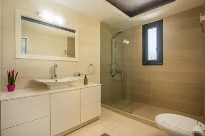 a bathroom with a sink toilet and a shower at Villa Melia in Koskinou