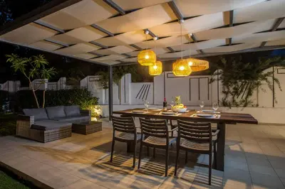 a patio with a table and chairs and a couch at Villa Melia in Koskinou