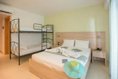 a bedroom with two bunk beds and a hat on a bed at Meliton Hotel in Theologos
