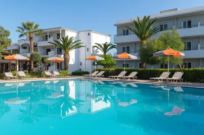 a pool at a hotel with chairs and umbrellas at Meliton Hotel in Theologos