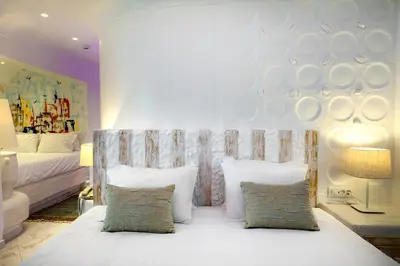 a bedroom with a bed with white pillows at Rhodos Horizon Blu-Adults Only in Rhodes Town