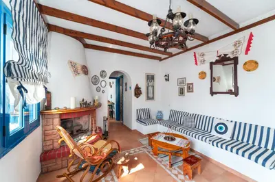 a living room with a fireplace and a couch at Irene's house in Lachania