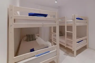 two white bunk beds in a room at Maria & Nada Beachfront Villas in Kolimbia