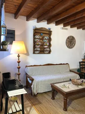 a living room with a couch and a table at Villa Smaragdi-Despoina in Malona Village