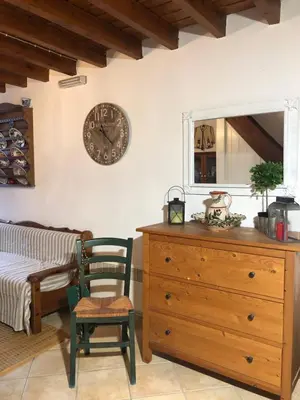 a bedroom with a dresser and a clock on the wall at Villa Smaragdi-Despoina in Malona Village