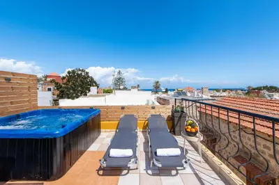 a rooftop deck with a hot tub and lounge chairs at A Unique 3-4 bedrooms house in OLD TOWN in Rhodes Town
