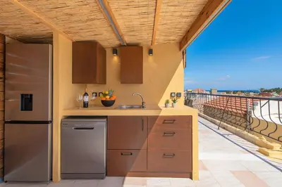 a kitchen with a refrigerator and a sink on a balcony at A Unique 3-4 bedrooms house in OLD TOWN in Rhodes Town