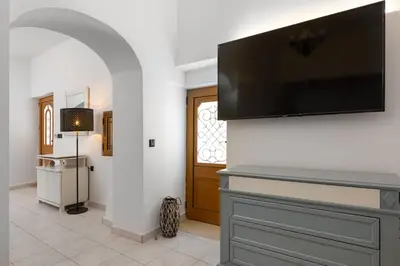 a living room with a flat screen tv on a wall at A Unique 3-4 bedrooms house in OLD TOWN in Rhodes Town
