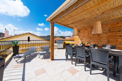 a patio with chairs and a table on a deck at A Unique 3-4 bedrooms house in OLD TOWN in Rhodes Town