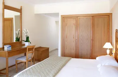 a bedroom with a bed and a desk and a table at Canvas by Mitsis Petit Palais in Rhodes Town