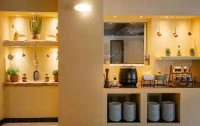 a kitchen with a counter with plates on it at Canvas by Mitsis Petit Palais in Rhodes Town