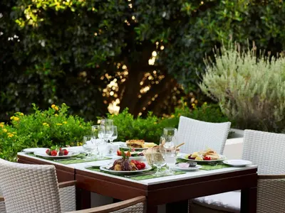 a table with plates of food and wine glasses at Mitsis Rodos Maris in Kiotari