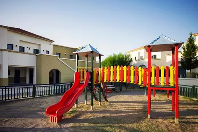 a playground with a red and yellow slide at Mitsis Rodos Maris in Kiotari