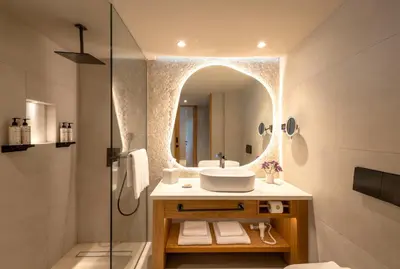 a bathroom with a sink and a mirror at Mitsis Rodos Village in Kiotari