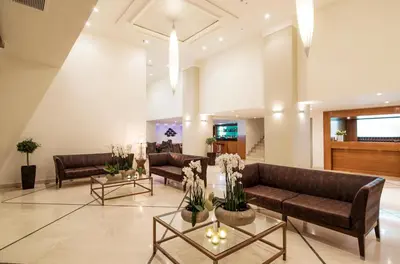 a lobby with couches and tables in a building at Mitsis La Vita in Rhodes Town