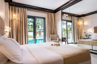 a bedroom with a large bed and a large window at Mitsis Faliraki in Faliraki