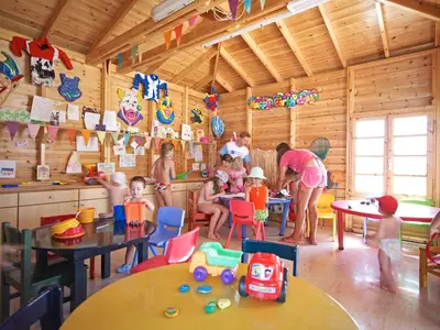 a group of children playing in a wooden room at Mitsis Faliraki in Faliraki