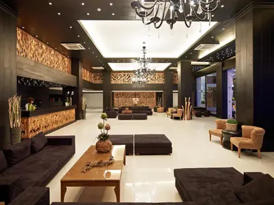 a large living room with couches and a chandelier at Mitsis Faliraki in Faliraki