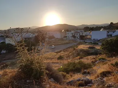 a sunset over a town with a road and buildings at Haraki Sunrise Apartments in Haraki